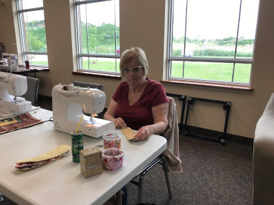 lady sitting in front of sewing machine